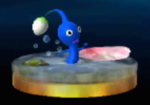 The trophy for a Blue Pikmin in the 3DS version of Super Smash Bros. for Nintendo 3DS and Wii U, walking through water and beside a pink petal.