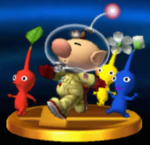 The trophy for Captain Olimar in the 3DS version of Super Smash Bros. for Nintendo 3DS and Wii U, followed by a Red Pikmin, Yellow Pikmin, and Blue Pikmin.