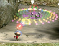 Captain Olimar whistles at a few idle Red Pikmin.