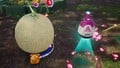 The treasure being carried by multiple Blue Pikmin and Oatchi back to the S.S. Beagle.