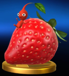 The trophy for a Red Pikmin in the Wii U version of Super Smash Bros. for Nintendo 3DS and Wii U, sliding down a Sunseed Berry.