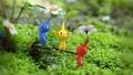 Promotional art of the three original Pikmin types.