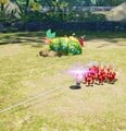 An Armored Cannon Larva throwing Pikmin off of its back.