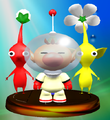 The Captain Olimar trophy, with a Red Pikmin and Yellow Pikmin behind him.