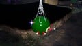 Four Red Pikmin latching onto the treasure, attempting to pull it down.
