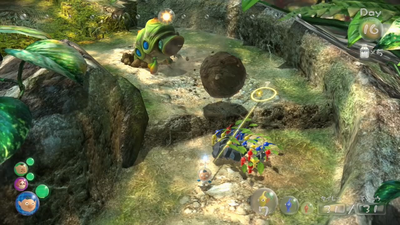 An Armored Cannon Larva fires a rock at a group of Pikmin.