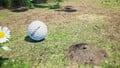 An alternative, more close-up, shot of the treasure in the location it is discovered, next to a dug-out dirt-mound.
