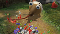 E3 2012 screenshot of a Whiptongue Bulborb capturing Pikmin with its tongue.