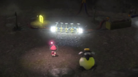 A screenshot from a cutscene introducing Yellow Pikmin in Pikmin 3, where the Pikmin complete an electric circuit.