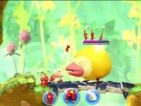 An unknown yellow enemy from Hey! Pikmin, fighting with some Red Pikmin.