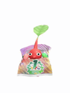 An animation of a Red Pikmin with a First Anniversary Snack from Pikmin Bloom