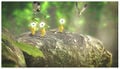 A screenshot of Pikmin 3 featuring some Yellow Pikmin sitting on a rock, along with a few White Spectralids.