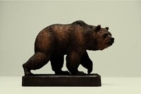 A real world wooden sculpture of a bear.