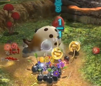 Some Rock Pikmin recovering Golden Cupid's Grenades.