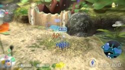 A screenshot from a promotional video for Pikmin 3 Deluxe, showing a dirt wall being charged at by only Red Pikmin. From https://youtu.be/hSujRBzq9QE?t=20