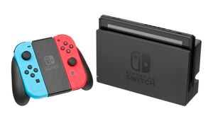 The Nintendo Switch in docked mode, with red and blue Joy-Con in a Joy-Con grip.