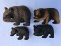 Various wooden sculptures of a bear fishing (木彫り熊?, lit.: "wooden carved bear") from the real world.