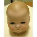The head of a baby doll in the real world.