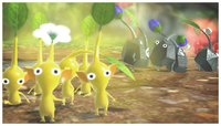 A few Yellow Pikmin facing the camera. Some Rock Pikmin and Red Pikmin appear in the background.