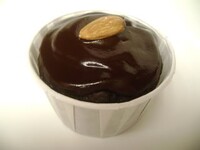 A real world chocolate cupcake with an almond.
