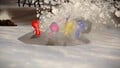 Some Pikmin digging out a Yellow 5 pellet.