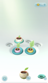 A screenshot of the Planter Pack in Pikmin Bloom. A yellow seedling is nearly fully grown, a pink seedling is about half-grown, and a huge seedling in a single-use slot is only slightly grown.